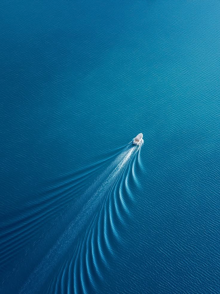 Aerial view of a vessel crossing open blue water